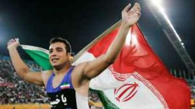 Ehsan Hadadi celebrates his win in the men's discus throw finals at the 15th Asian Games in Doha.