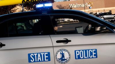 A Virginia State Police officer watches the police line set up at the site of Tuesdays fatal shooting. Getty Images / AFP