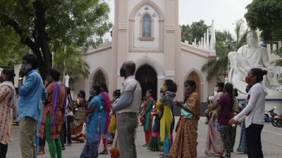People wait to receive food during a lockdown imposed against the spread of Covid-19, at Saint Marys Basilica in Secunderabad, the twin city of Hyderabad. AFP
