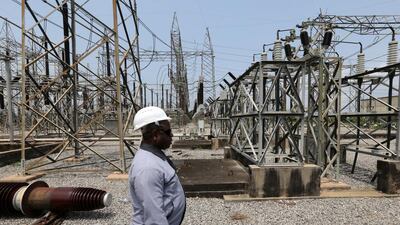 An employee walks past electricity pylons carrying high voltage cables at the newly renovated energy generation plant in Lagos, Nigeria. In much of the continent, regular supply is a distant dream. George Osodi/Bloomberg