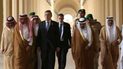 The British prime minister Gordon Brown, centre, walks with Saudi officials on his arrival at King Saud university in Riyadh today.