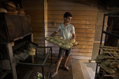 A bakery worker in Cairo, where many residents are feeling the pinch. Bloomberg.