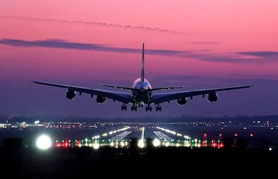 An Emirates Airbus A380 lands during sunrise at London Gatwick Airport. PA
