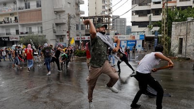 Hezbollah supporters and communist groups throw stones at riot police during a protest against US interference in Lebanon's affairs, near the American embassy in Aukar, north-east of Beirut, Lebanon. AP Photo