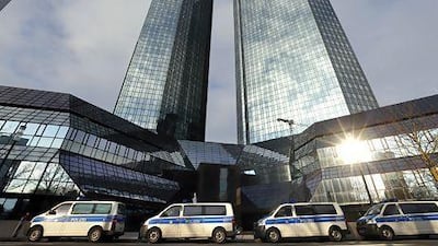 Police vehicles line up outside Deutsche Bank's Frankfurt HQ as part of an investigation into alleged involvement in tax evasion. Kai Pfaffenbach / Reuters