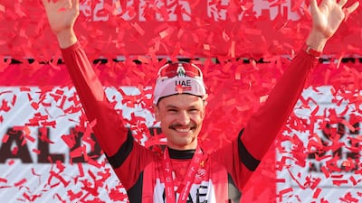 UAE Team Emirates' Australian cyclist Jay Vine celebrates in the red jersey after he maintained his lead in the race's general classification after Stage 6. AFP