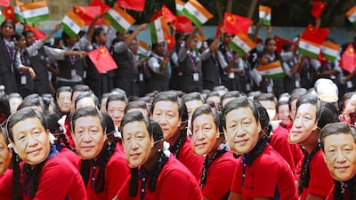 Students wear masks of China's President Xi Jinping in Chennai, India. Reuters