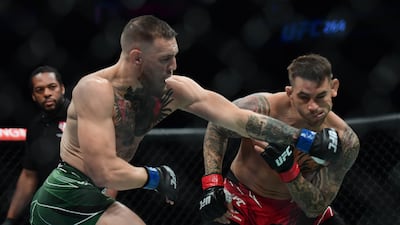 Conor McGregor moves in for a hit against Dustin Poirier during UFC 264 at T-Mobile Arena.