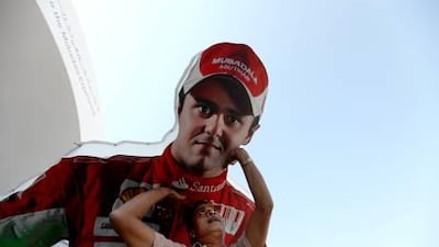 A worker yesterday dismantles and loads an oversized billboard of the Ferrari F1 driver, Felipe Massa, onto a lorry at the F1 FanZone on the Corniche.
