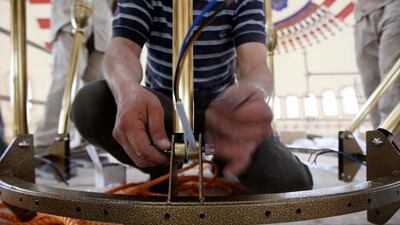 Workers install the first ring of the chandelier at the Al Farooq mosque in Al Safa area in Dubai.