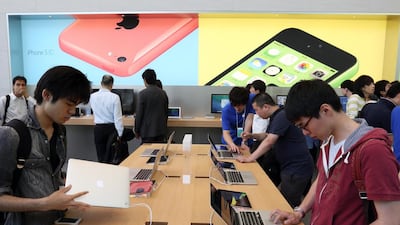 Customers at Apple’s Omotesando shop during its opening in Tokyo, Japan, two months ago. The tech giant has advertised for retail positions in the UAE, sparking hopes of a shop opening here. Tomohiro Ohsumi / Bloomberg