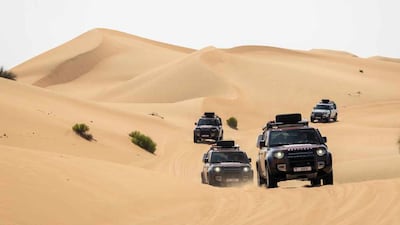 A posse of Land Rover Defender 130s get moving through the sands of Dubai. All photos: JLR