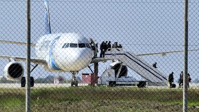 Passengers evacuate the hijacked EgyptAir Airbus 320 plane at Larnaca airport, Cyprus, on March 29, 2016. Yiannis Kourtoglou / Reuters