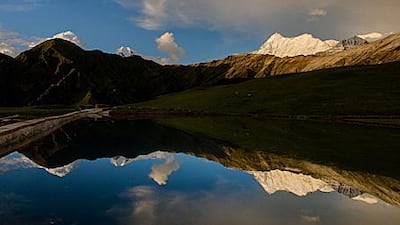 The imposing peaks of the Trishul mountains loom over Bedni Bugyal, a lush meadow with a small lake in its midst. Bedni Bugyal, situated 3,354m above sea level, is an overnight stop on the trek to Roopkund.