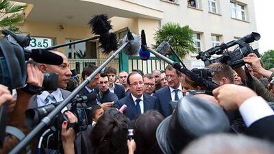 France's president Francois Hollande speaks with residents and journalists in Clichy-sous-Bois, outside Paris. Bertrand Langlois / AFP
