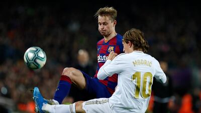 Barcelona's Frenkie de Jong, left, passes the ball as Real Madrid's Luka Modric defends. AP