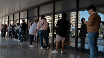 People queue outside a transport office in Madrid. Reuters
