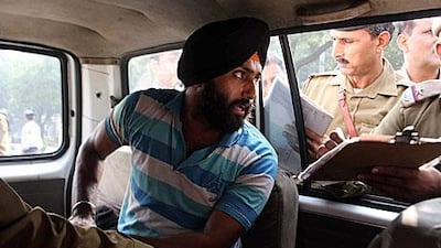Harvinder Singh, the man identified to slapping Sharad Pawar, India's agricultural minister, is detained in a police car after his attack on the politican.