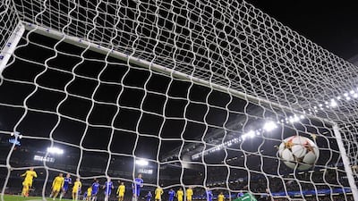 Chelsea's Cesc Fabregas, back, centre, scores his side's first goal on a penalty past Sporting Lisbon keeper Rui Patricio in Chelsea's 3-1 Champions League victory on Wednesday night in London. Glyn Kirk / AFP