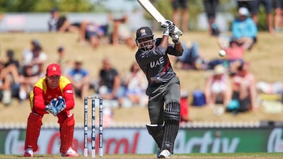 Krishnachandran Karate of the UAE bats while Brendan Taylor of Zimbabwe looks on during the 2015 ICC Cricket World Cup match at Saxton Field on February 19, 2015 in Nelson, New Zealand. Hagen Hopkins/Getty Images