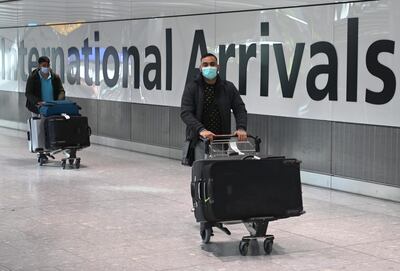 Passengers arrive at London's Heathrow Airport during the coronavirus pandemic. EPA
