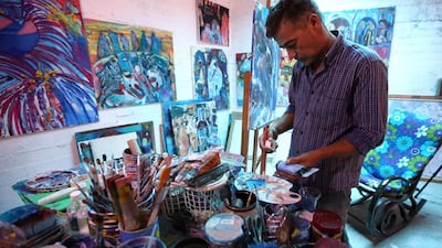 Libyan painter Youssef Ftis works in his studio in the capital Tripoli. Despite the restrictions brought by the civil war, he is hopeful there is a good future for the Libyan art scene and determinedly keeps working on his craft. Mahmud Turkia / AFP
