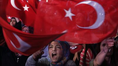 Turks wave national flags and shout slogans during an anti-coup rally in Istanbul on July 25, 2016. Petros Karadjias, File/AP Photo