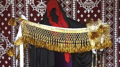 Umm Khalid, from Saudi Arabia, is considered the queen of camel bling and has been making it for a decade producing pieces like the one she is holding, which is called a Jeneeba - a camel body decoration. Jeff Topping / The National