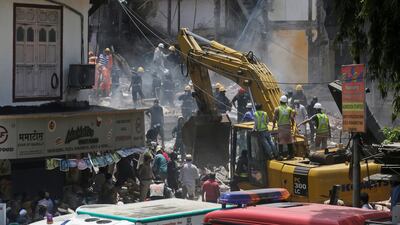 Rescue workers clear debris. Rafiq Maqbool / AP Photo