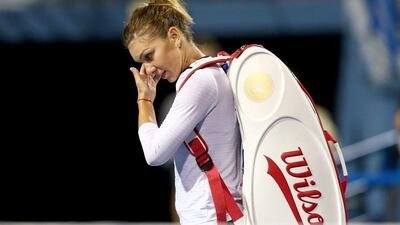 Simona Halep walks off the court after her loss to Magdalena Rybarikova at the second round of the WTA Connecticut Open on Tuesday. Elsa / Getty Images / August 19, 2014