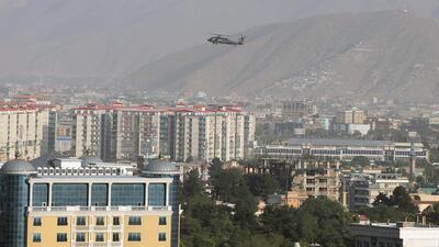 A Nato helicopter flies over the city of Kabul, Afghanistan, on June 29, 2020. Reuters