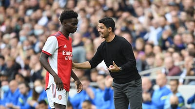 Arsenal manager Mikel Arteta talks to Bukayo Saka during the pre-season friendly at the Tottenham Hotspur Stadium.