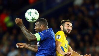 Wes Morgan, left, of Leicester City in action against FC Porto’s Adrian Lopez. Tim Keeton / EPA