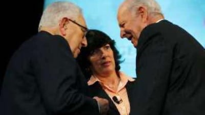 Harry Kissinger, left, and James Baker, former secretaries of state, talk as CNN chief international correspondent Christiane Amanpour looks on at George Washington University in Washington on Monday.