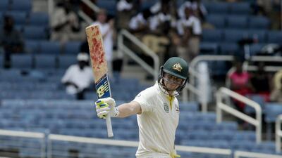 Australia batsman Steven Smith raises his bat after reaching 150 runs during Day 2 of the second Test against West Indies in Kingston, Jamaica. Arnulfo Franco / AP / June 12, 2015