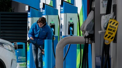 A driver plugs in his electric vehicle at a Motor Fuel Group station in the UK, which will host the Cop26 summit in November. Getty Images