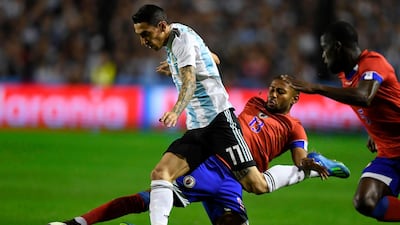 Argentina's Angel di Maria is tackled by Haiti's Mikael Cantave. Eitan Abramovich / AFP