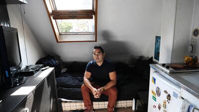 Ivan Lopez poses at his flat, which measures ess than 7 square metres, in the 5th district of Paris, on September 14, 2016. Thomas Samson / AFP