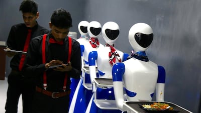 Stewards still work at the restaurant, and check the incoming food orders on a tablet. At the first of its kind Restaurant in Bangalore, six robots are deployed as waiters. Photo: EPA/JAGADEESH
