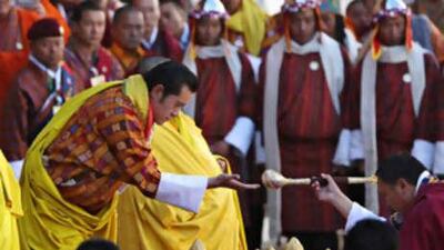 The new king of Bhutan, Jigme Khesar Namgyel Wangchuck (left) takes part in a religious ceremony moments before his coronation in Thimphu.