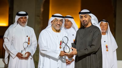 Sheikh Mohamed presents an Abu Dhabi Award to Abdulrahman Al Owais, Minister of State for Federal National Council Affairs, who received it on behalf of his late father, Sultan Al Owais