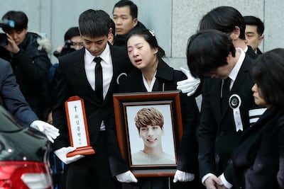 Relatives weep during the funeral of Kim Jong-hyun, the lead vocalist of the K-pop group SHINee. Getty