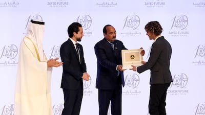 Thomas Samuel, chief executive of Sunna Design, collects the Zayed Future Energy Prize for Small and Medium and Enterprises from Sheikh Mohammed bin Zayed, Crown Prince of Abu Dhabi, Prince Hussein bin Abdullah, Crown Prince of Jordan, and Mohammed Ould Abdel Aziz, President of Mauritiana, on Monday. Chris Whiteoak / The National