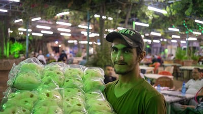 A vendor selling sweets at Tal Olya Cafe in Tripoli during Ramadan