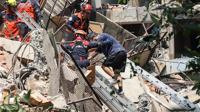 Emergency workers search the rubble of a building for survivors. AFP