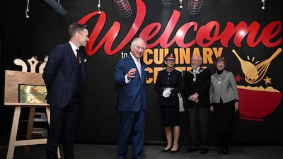 King Charles unveils a plaque to mark the 100th anniversary of Kellogg's. AFP