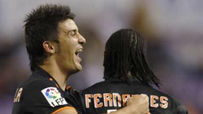 Valencia's Manuel Fernandes, right, is congratulated for his goal against Valladolid by his teammate David Villa.
