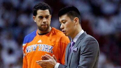 Jeremy Lin speaks to a teammate on the sidelines of the game against Miami.