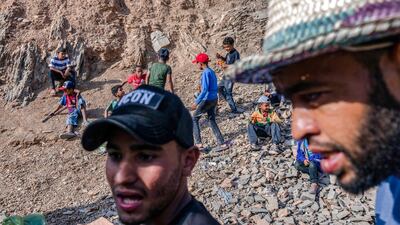 Survivors wait for assistance from volunteers. AFP