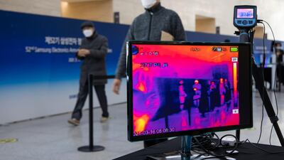 An attendee walks past a temperature screening checkpoint at the Samsung Electronics Co. annual general meeting held at the Suwon Convention Center in Suwon, South Korea. Huawei Technologies Co. will begin charging mobile giants like Samsung a "reasonable" fee for access to its trove of wireless 5G patents, potentially creating a lucrative revenue source by showcasing its global lead in next-generation networking. Bloomberg